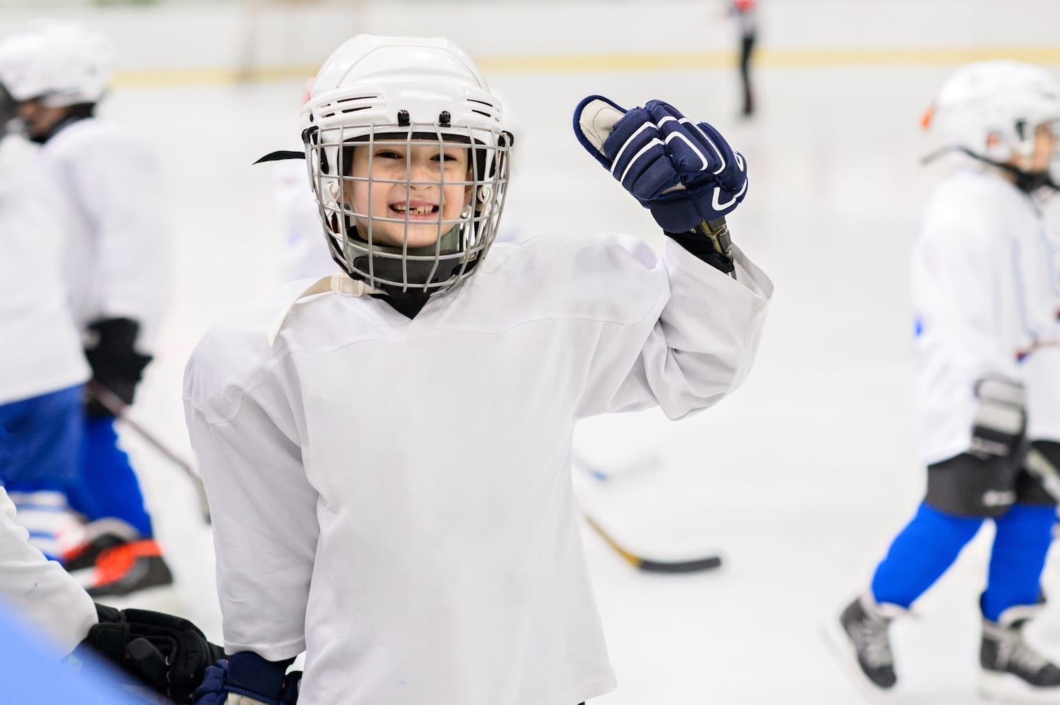 Hockey kid smiling to the camera.